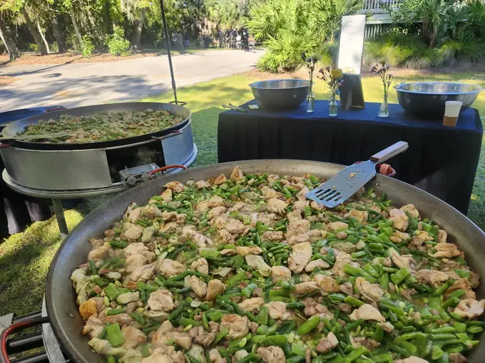 Paella Wedding & Event Catering in North Florida 6 Chicken and green bean paella cooking at an outdoor garden event