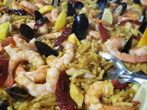 Close-up of seafood paella with shrimp, mussels and red peppers